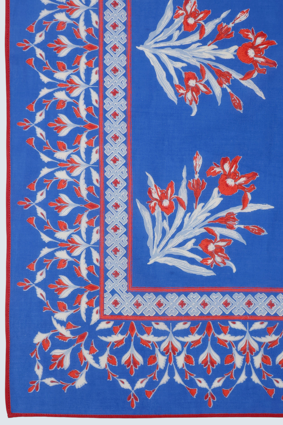 Close up of flat lay of Frances scarf in featuring hand block printed Brigitte print with iris flowers.