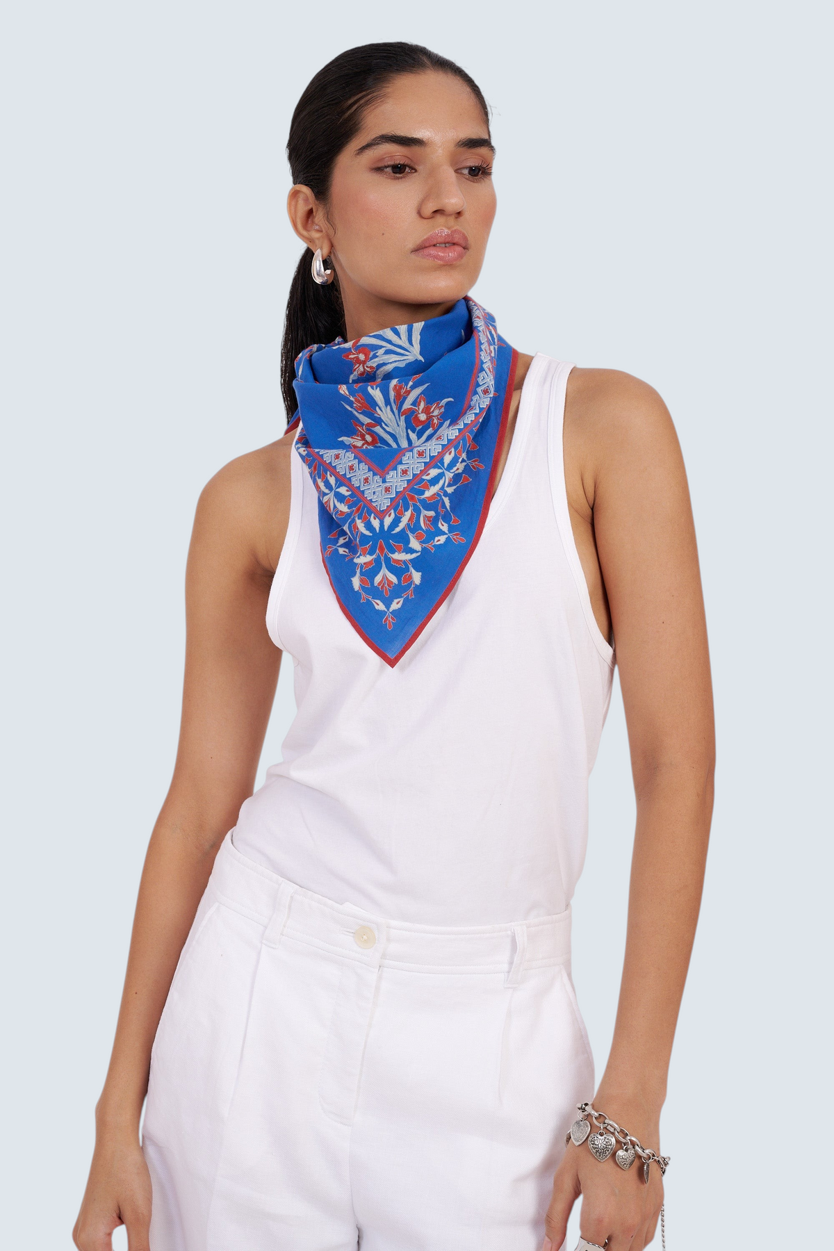 Banjanan Frances Scarf in blue cotton voile with hand-screened Brigitte iris floral print worn as a neckerchief