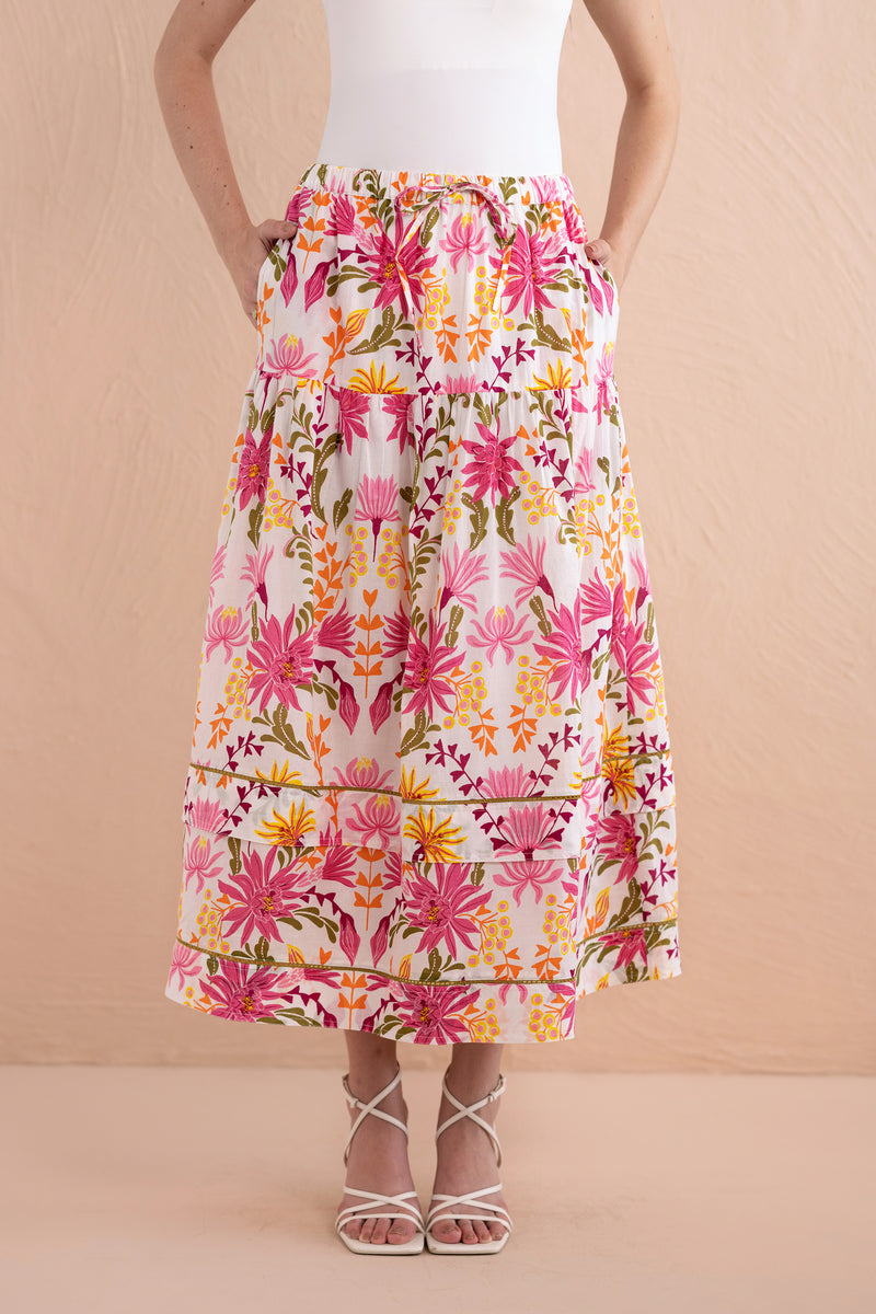 Front view close up of model wearing Gayle Skirt in Hydra Garland Rose with hands in her pocket.
