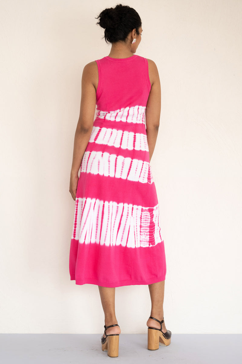 Back view of model wearing a sleeveless and calf length Genoa tie dyed dress.
