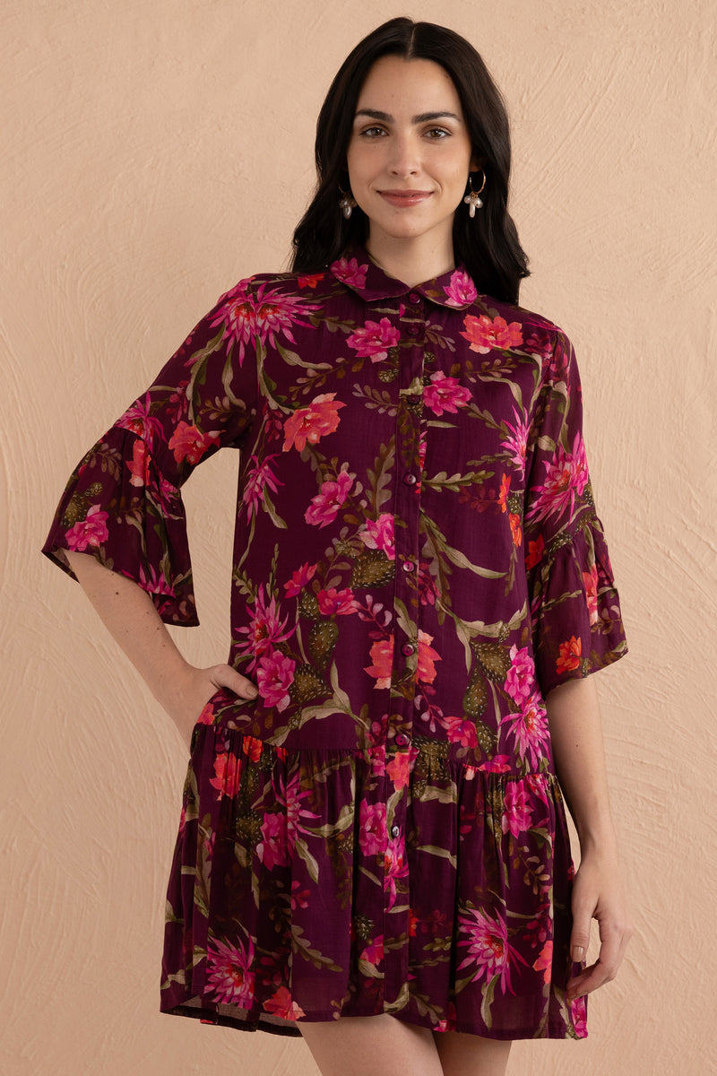 Front view close up of woman wearing Hydra Mini Dress in Desert Rose Dusk print, featuring a button placket, bell sleeves, slightly dropped waist, and side-seam pockets in lightweight viscose voile.