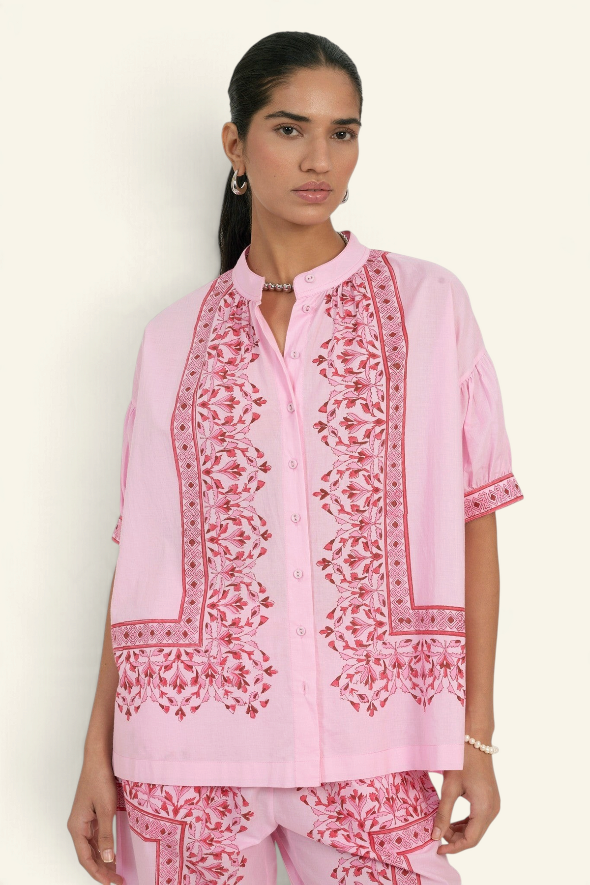 Banjanan Ivy shirt in pink cotton cambric with hand-blocked geometric floral print, button-down front, and gathers.