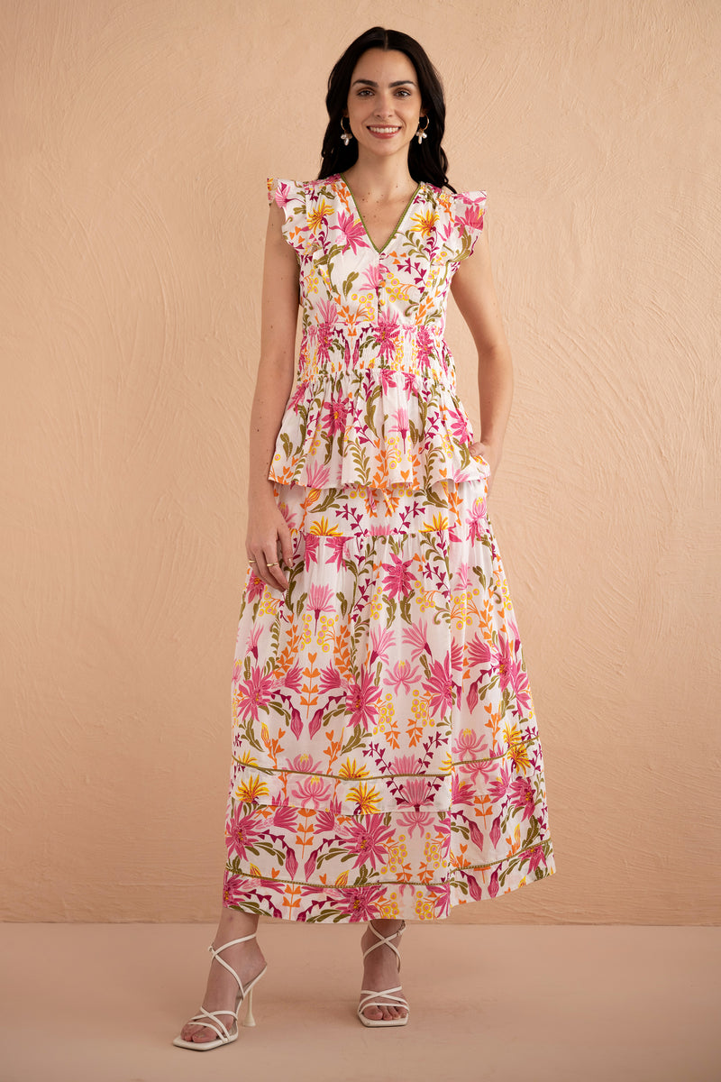 Front full view of model wearing Gayle Skirt paired with Kira Top in Hydra Garland Rose print with a hand in her pocket.