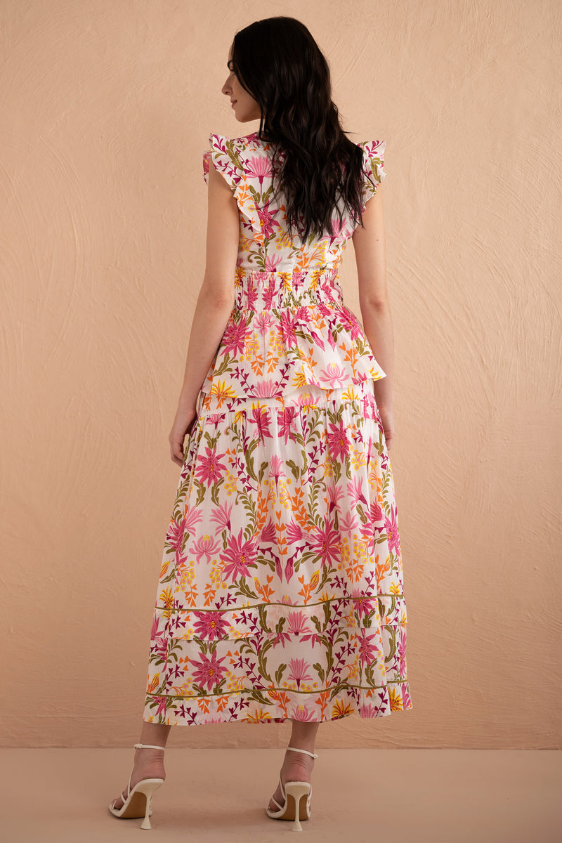 Back full view of model wearing Gayle Skirt paired with Kira Top in Hydra Garland Rose print with a hand in her pocket.