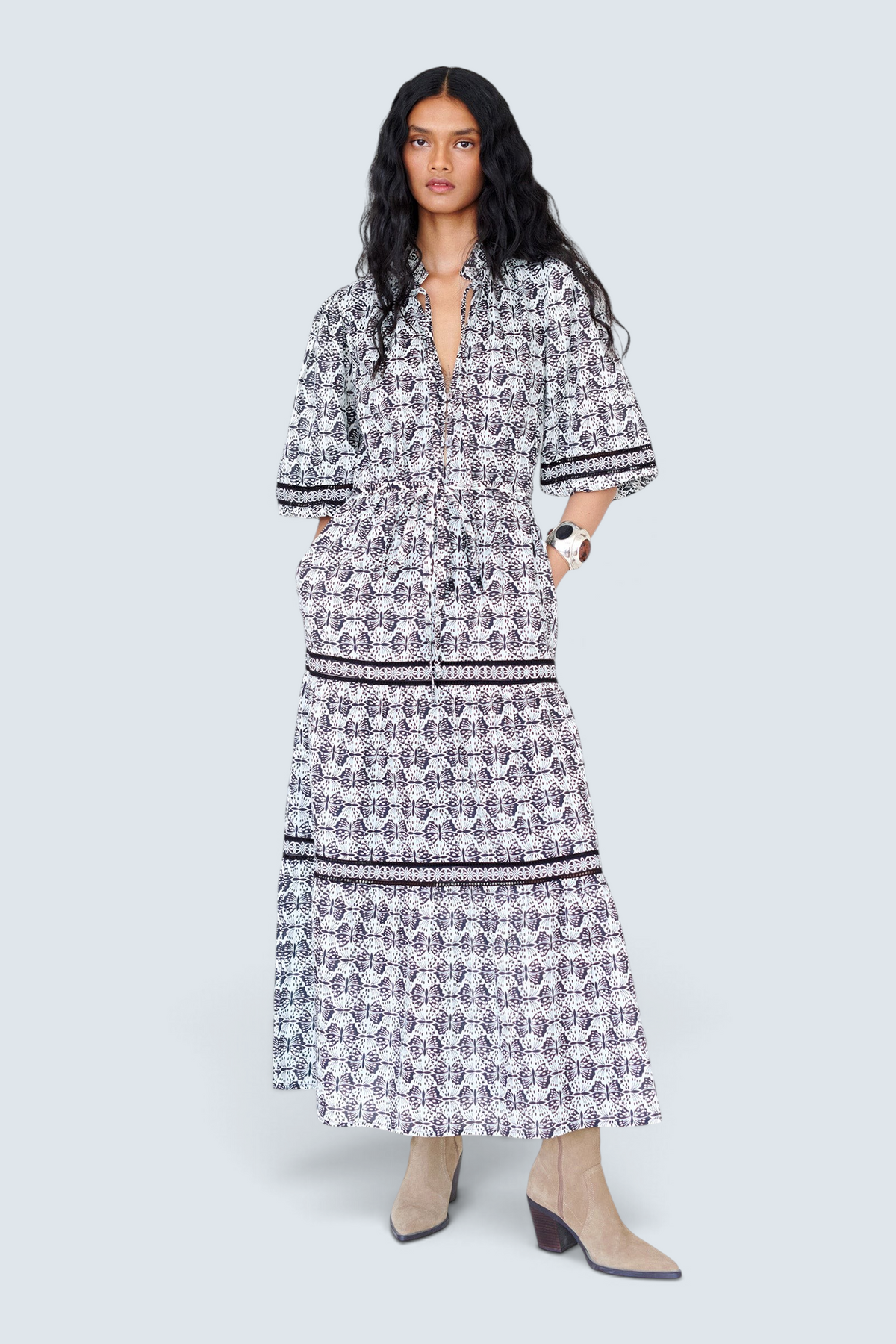 Woman wearing a black and white patterned dress on a white background