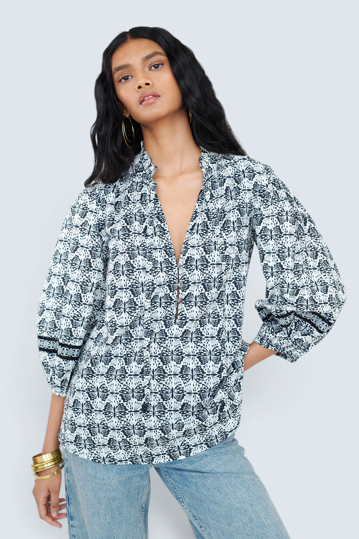 Banjanan Lorna top in black and white butterfly print cotton voile with v-neck, ruffle detail, and lace sleeves.