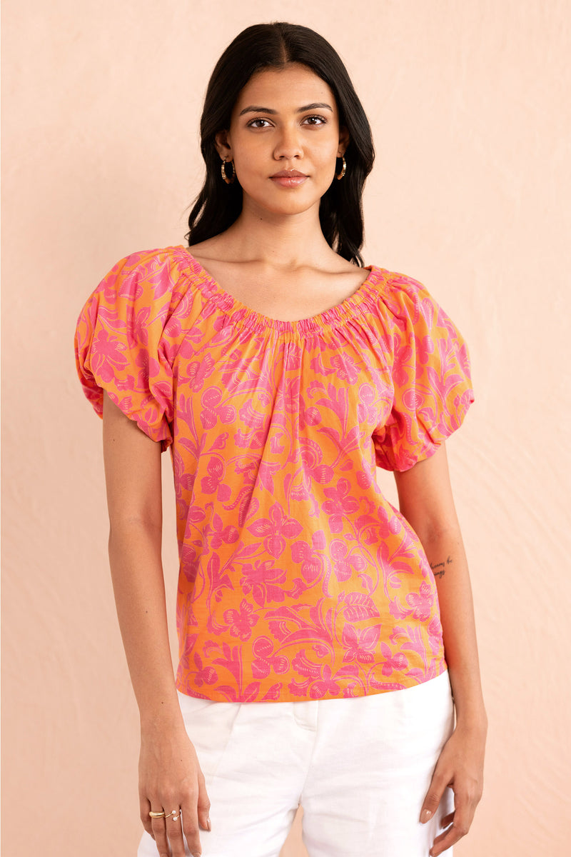 Front view close up of model wearing Louise Top in Gaia Nectarine print.