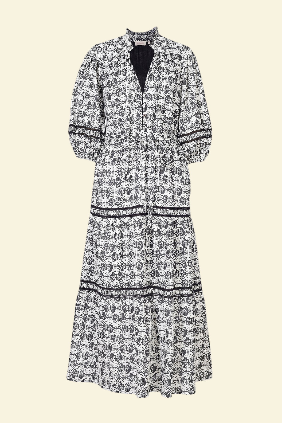 Banjanan Liza dress in black and white cotton voile with geometric butterfly print, lace insets, and ruffled neck.