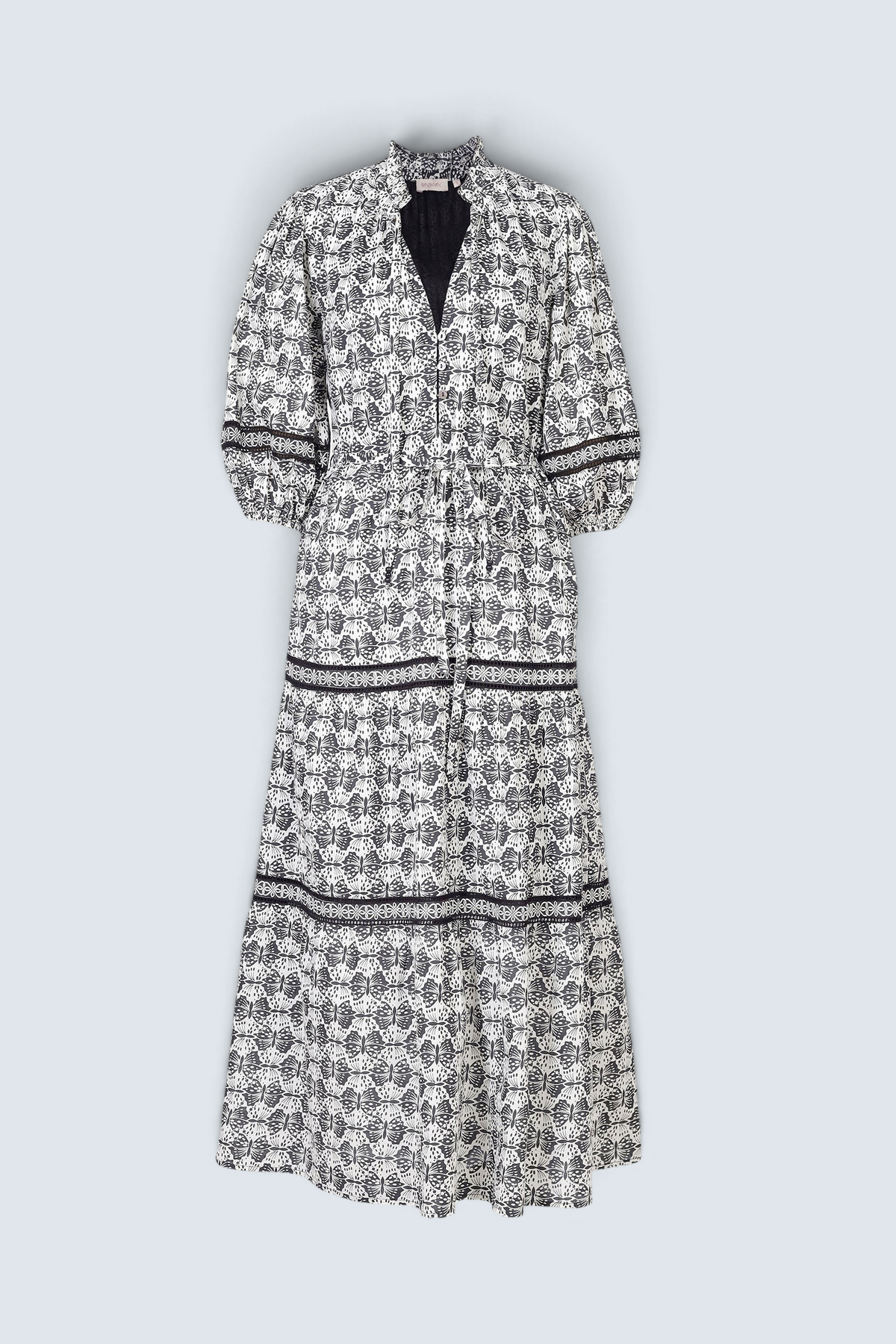 Banjanan Liza dress in black and white cotton voile with geometric butterfly print, lace insets, and ruffled neck.
