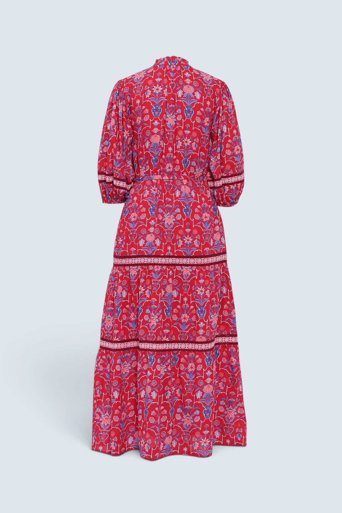 Back view of the Liza dress in Floral Vase print. It features a tie neckline, soft ruffles, lace sleeve and skirt details, and a fabric belt.