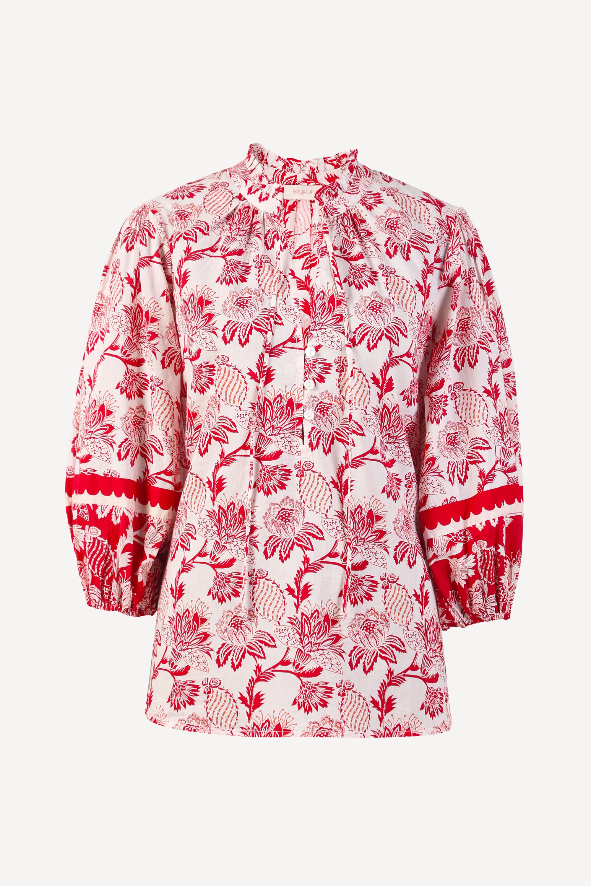 Front view of the Lorna top in the Lizzie print, featuring a V-neck with a soft ruffle, adjustable tie closure, voluminous sleeves, and winding floral vine motifs.
