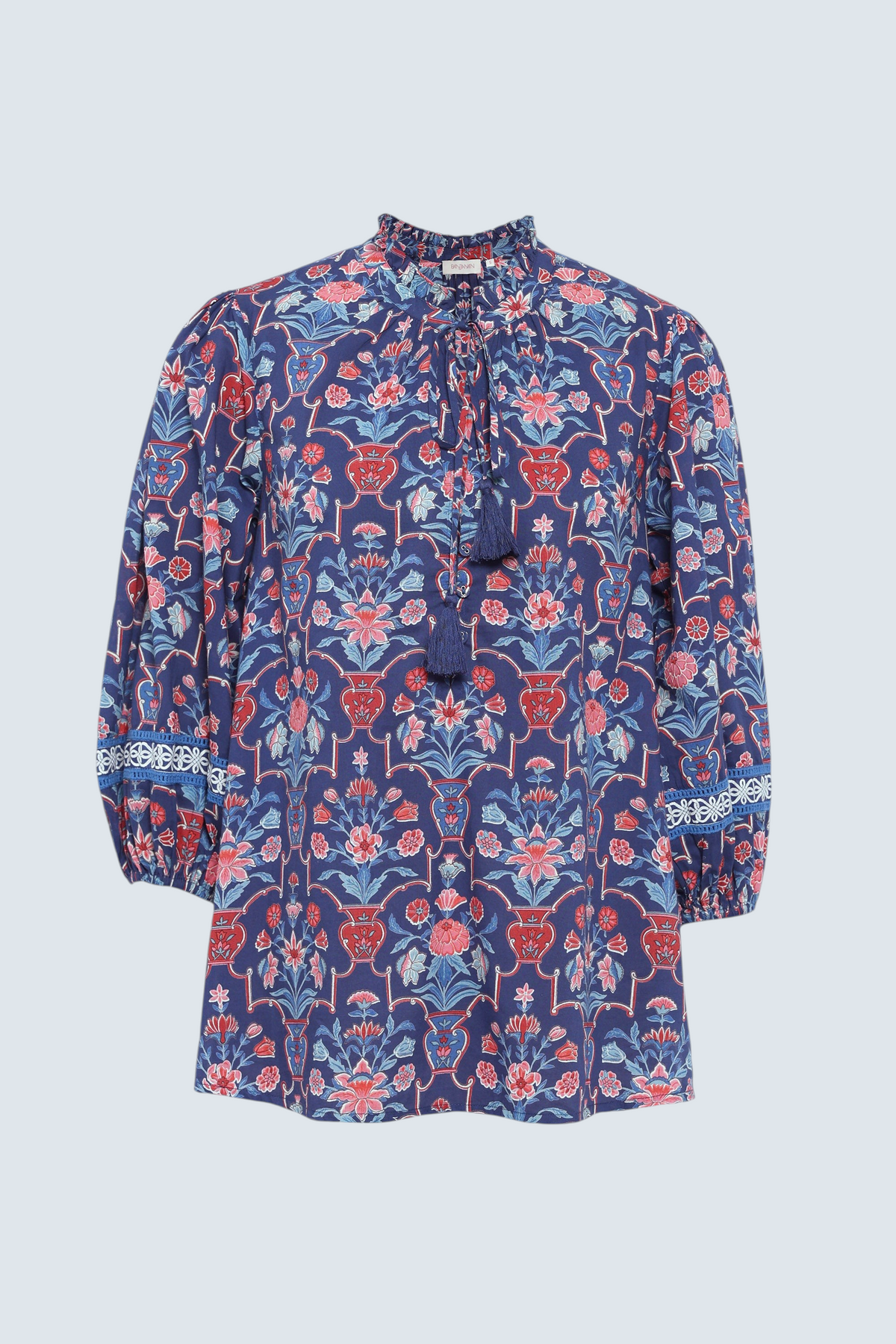 Front of Banjanan Lorna top in medieval blue cotton voile with floral vase print, v-neck, ruffle detail, and lace trim sleeves.