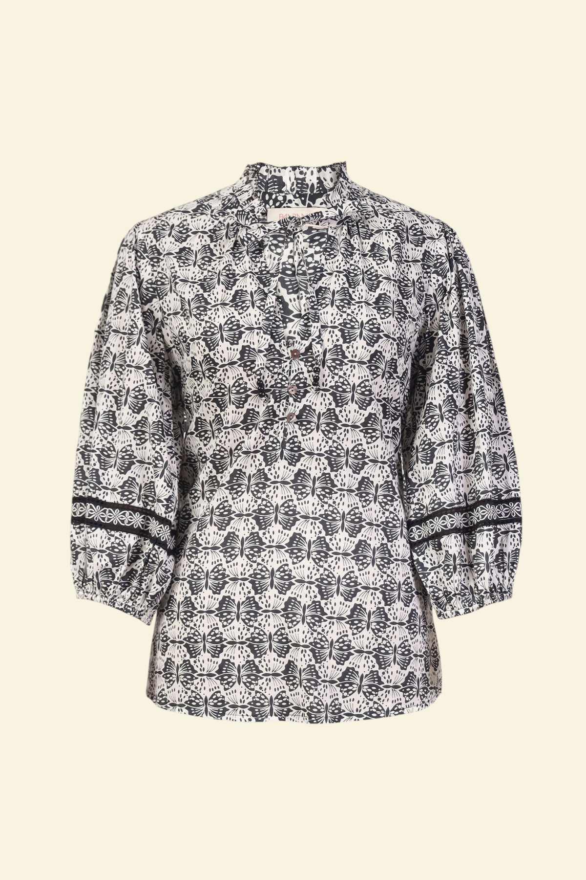 Banjanan Lorna top in black and white cotton voile with butterfly print, v-neck, ruffle trim, and lace sleeve detail.