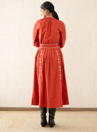 Back view of a woman wearing the Magdalena Skirt Sacher Rooibos, featuring exquisite embroidery inspired by Austrian folk art, side pockets, and a side zipper fastening.