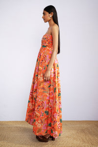 Side view of model wearing strapless maxi Madison Dress in Bali Floral Sunset print.