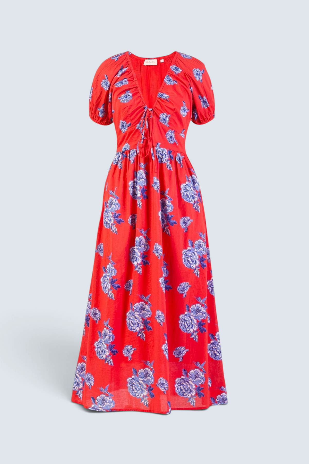 Banjanan Norma dress in poppy red with blue floral print, featuring a drawstring neckline and puff sleeves.