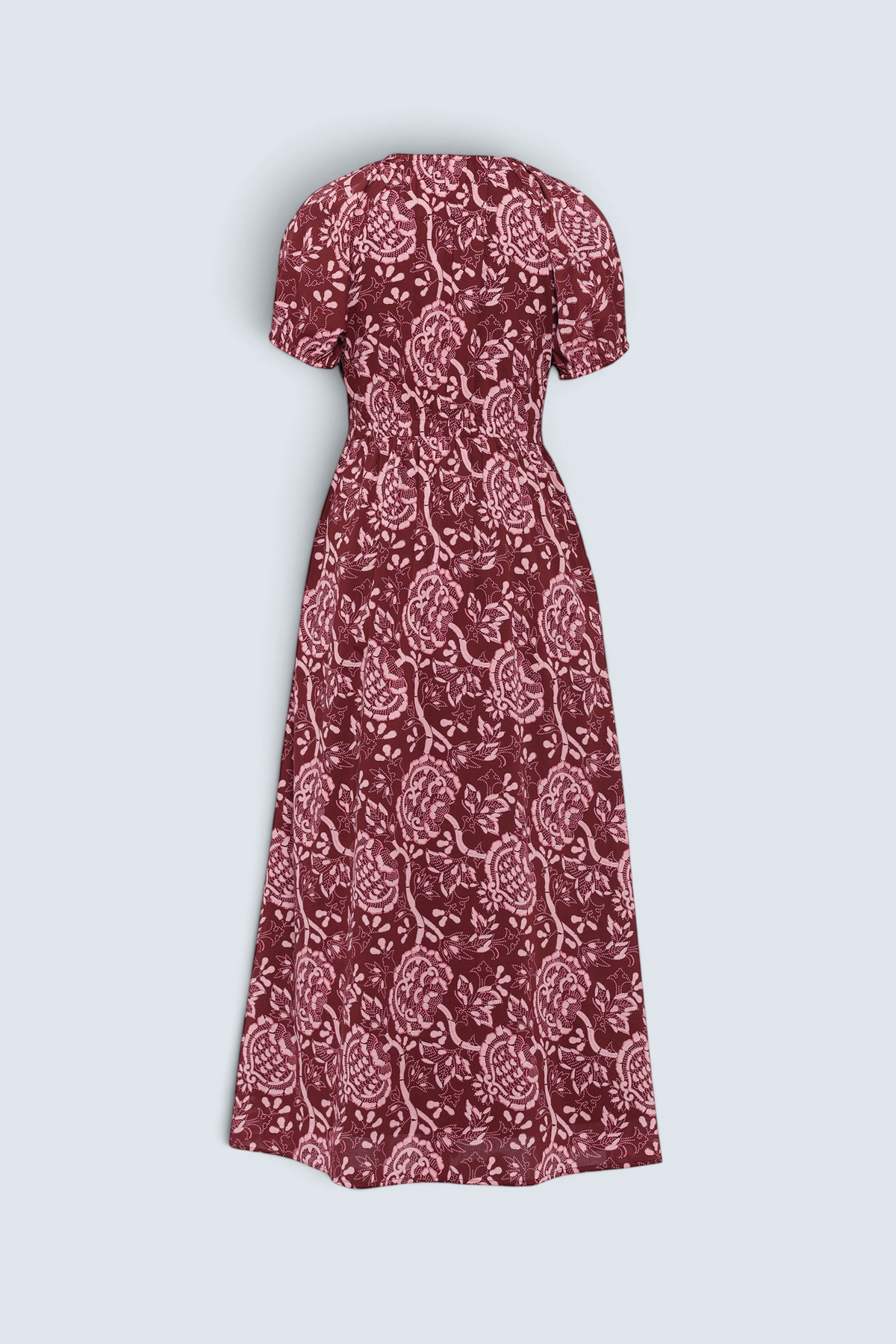 Back of Banjanan Norma dress in chocolate brown with a pink vintage-inspired floral print, featuring short elastic sleeves.