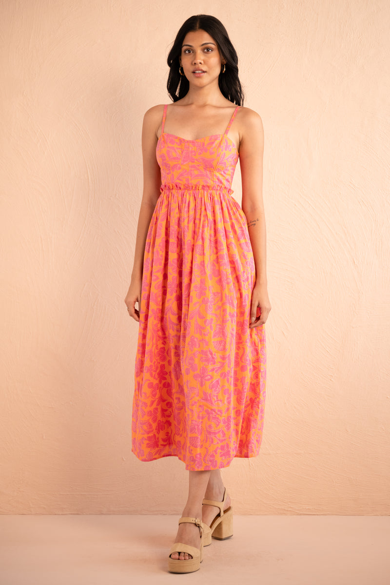 Front view of model posing wearing Phoebe Dress in Gaia Nectarine print.