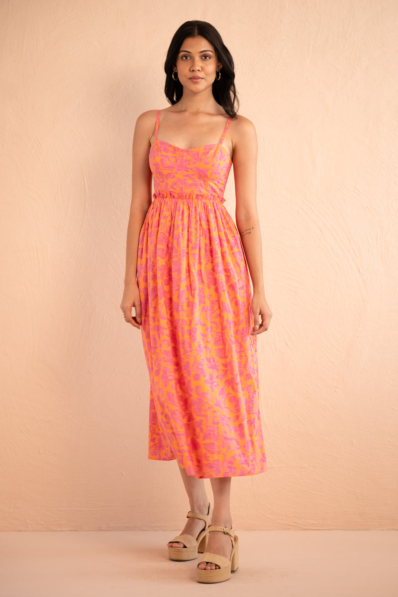Front view of model posing wearing Phoebe Dress in Gaia Nectarine print.