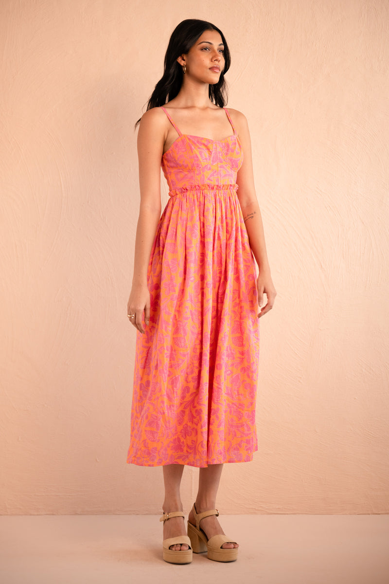 Front side view of model posing wearing Phoebe Dress in Gaia Nectarine print.
