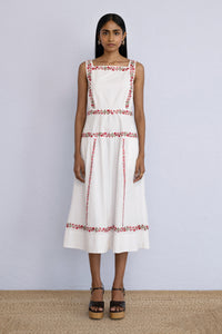 Front view of model standing straight wearing a midi length Rasia Dress in Calico Embroidery Ivory Flame.