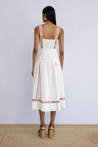 Back view of model standing straight wearing a midi length Rasia Dress in Calico Embroidery Ivory Flame.