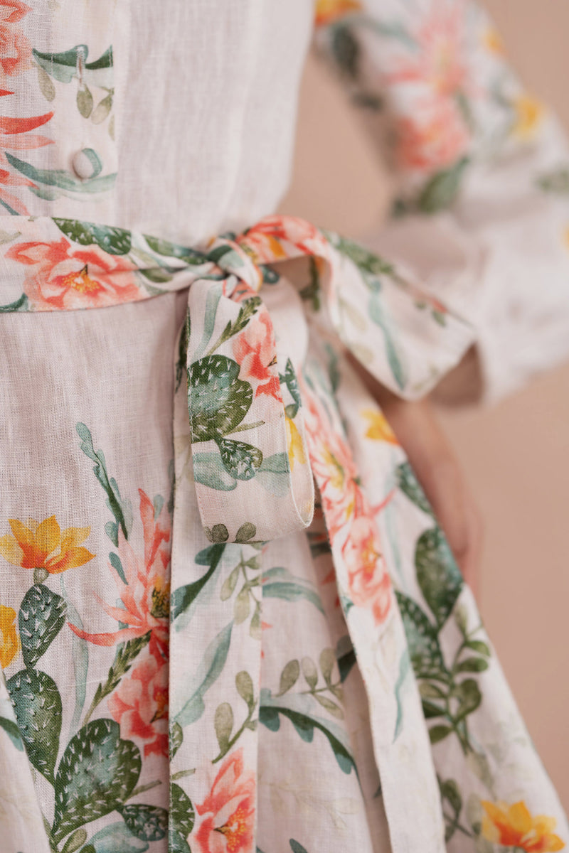 Belt tie detail close up woman wearing Rowena Dress in Desert Rose Dawn print.