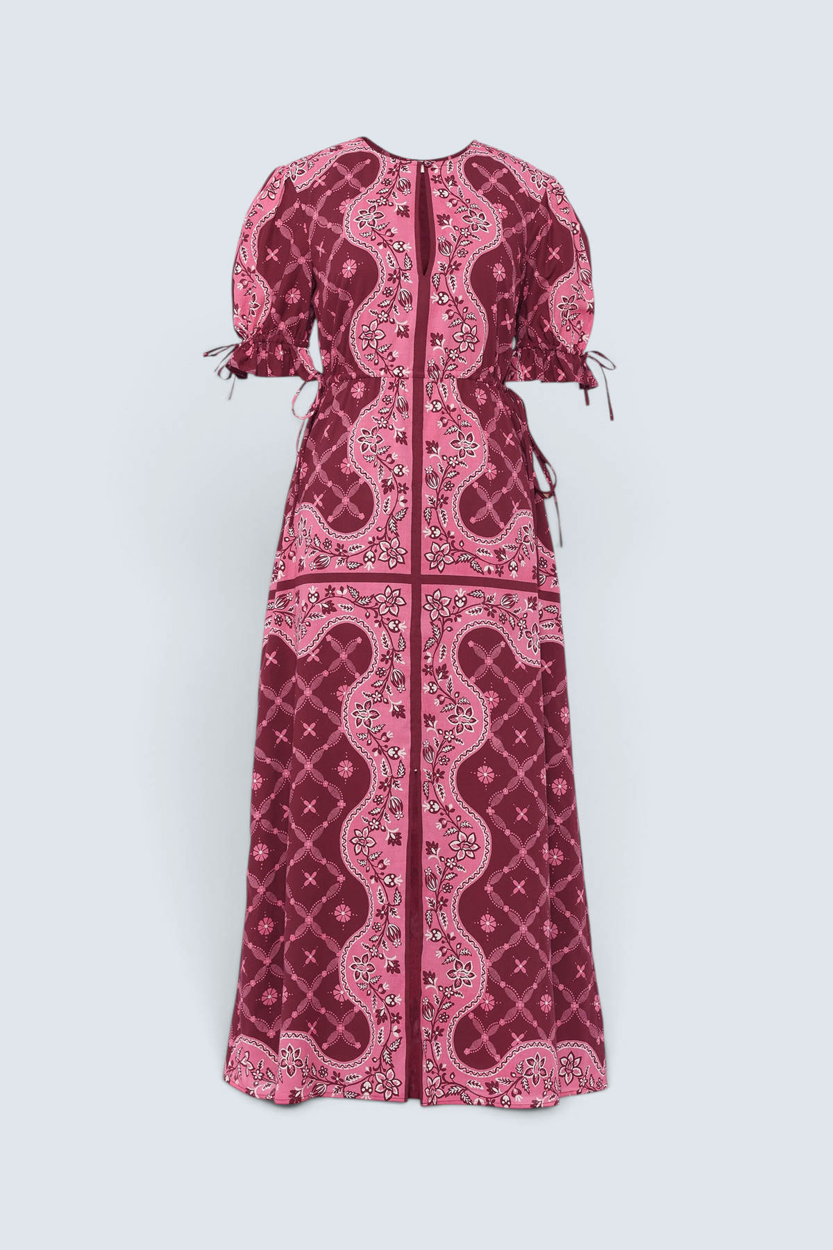 Front of Banjanan Ruby dress in pomegranate bandana print with keyhole neck, drawstring sleeves, and waist in a midi length.