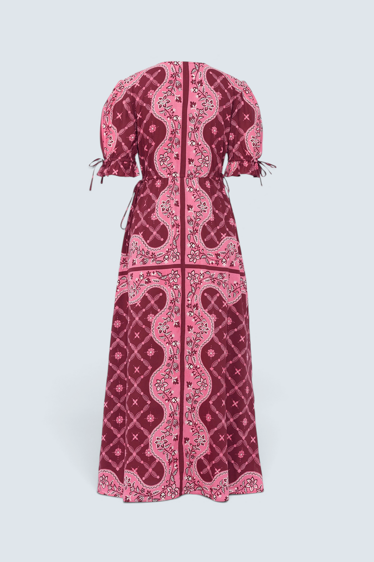 Back of Banjanan Ruby dress in pomegranate bandana print with drawstring sleeves and waist, back view.