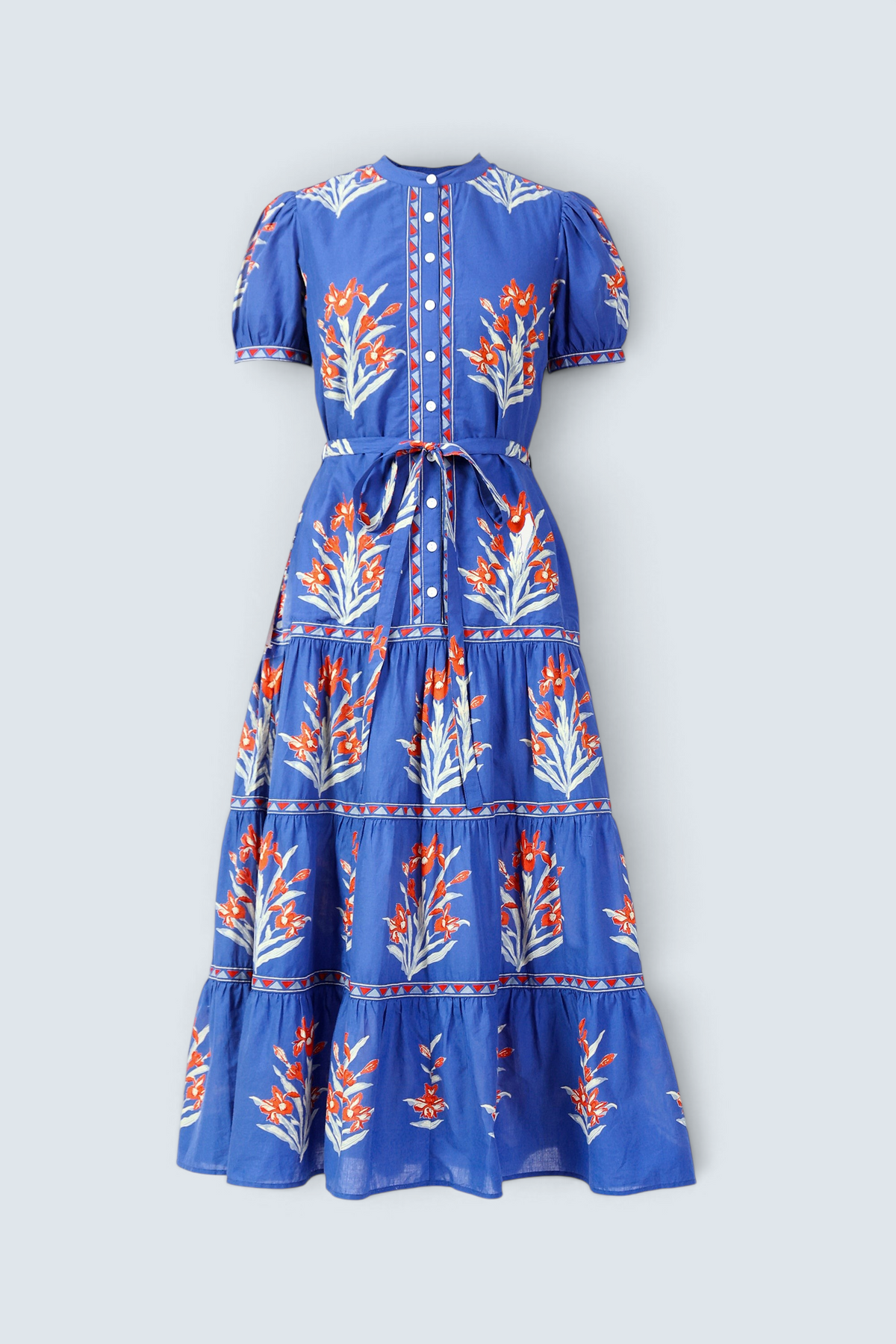 Front view of the Saylor dress in the Brigitte print, featuring a full-length shirtdress silhouette, tiered skirt, detachable belt, and hand-screen-printed iris floral motifs.