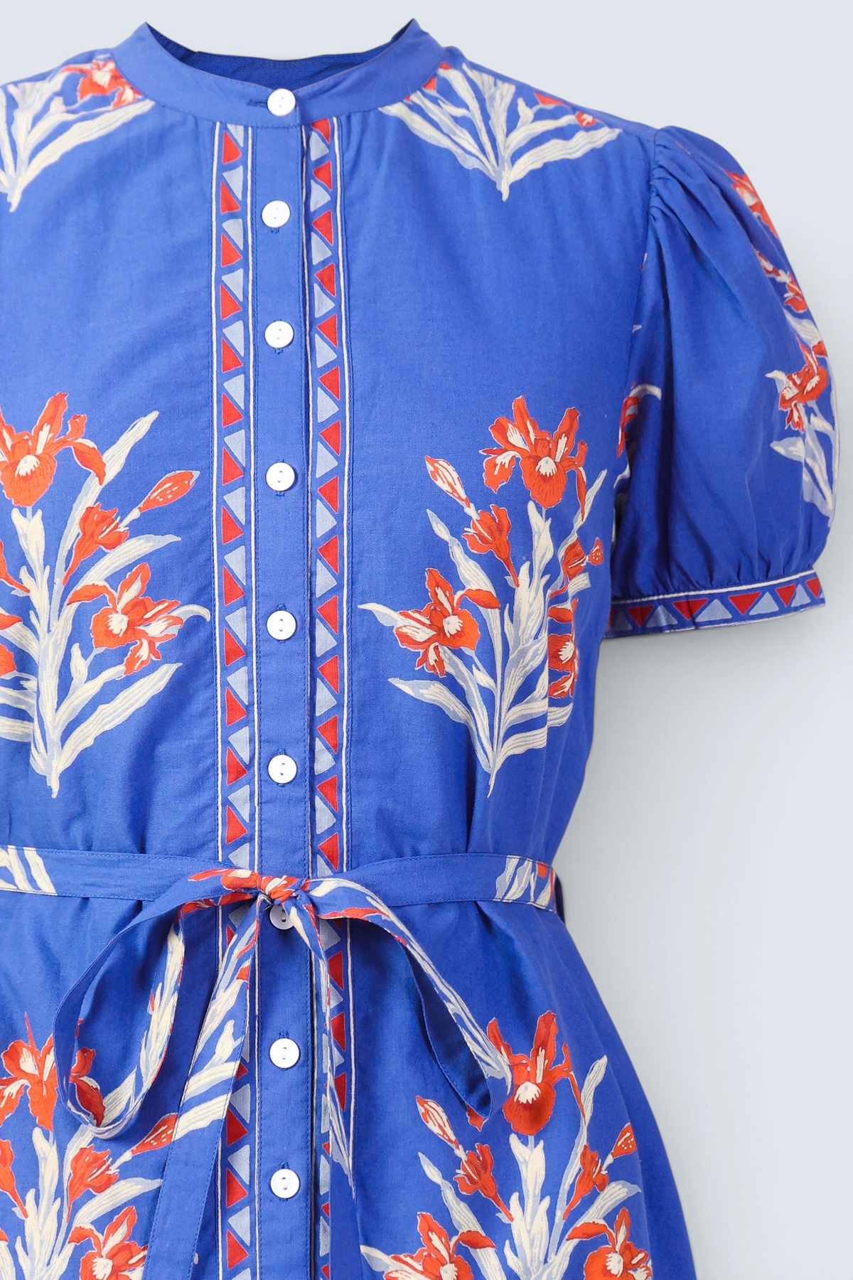 Front view close up of a woman standing wearing the Saylor dress in Brigitte print. It features detachable belt, and classic shirtdress silhouette in hand-screen-printed cotton voile.