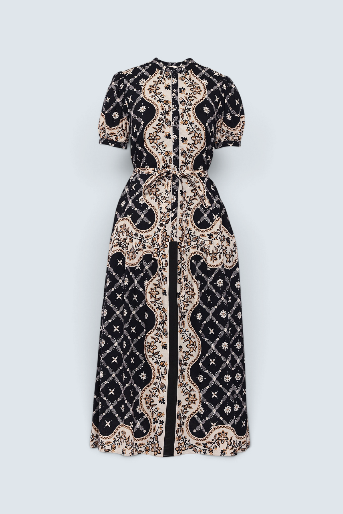 Front of Banjanan Saylor full-length shirtdress in black with a Victorian-inspired cream and gold bandana print and belt.