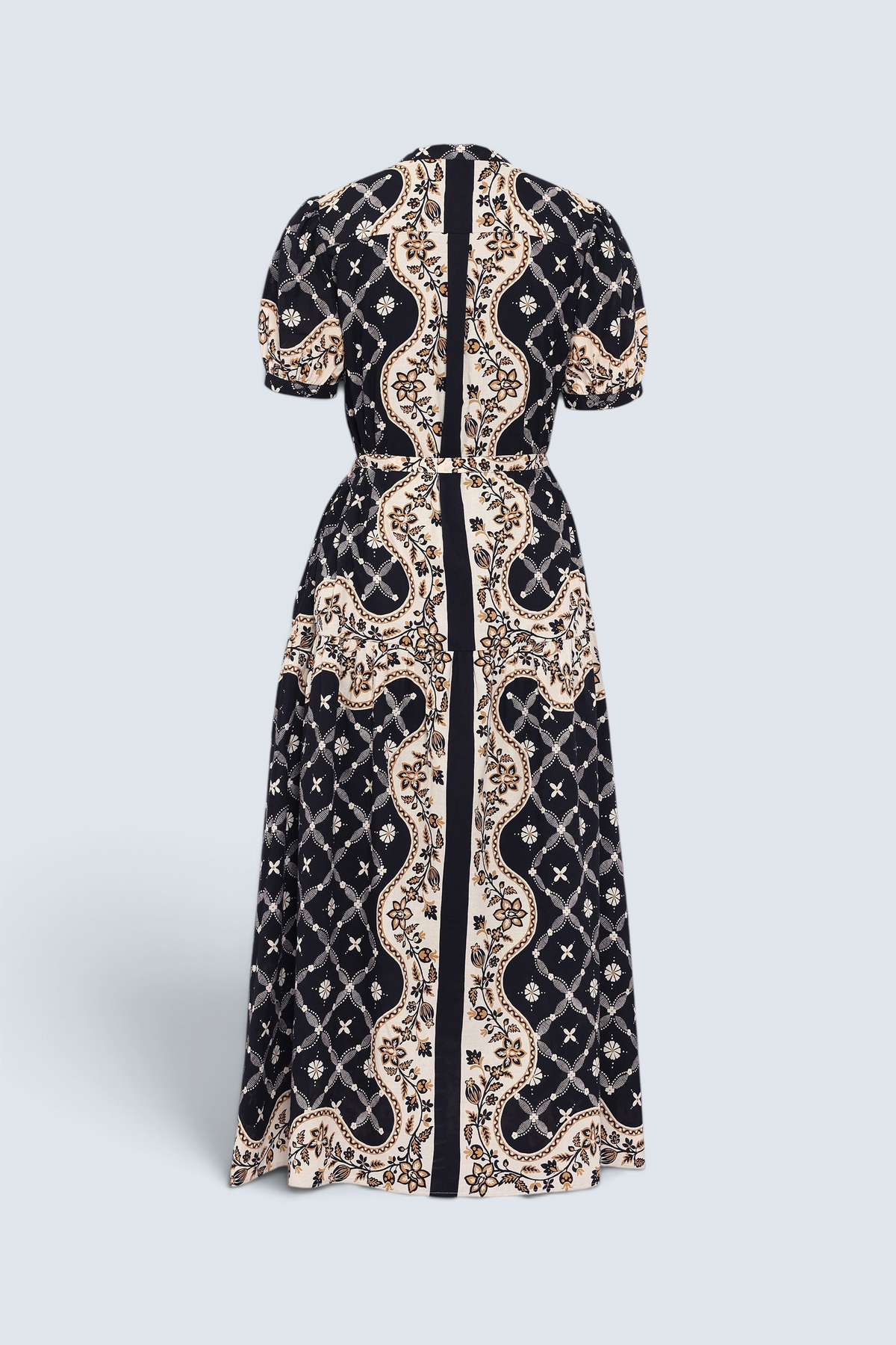 Back of Banjanan Saylor full-length shirtdress in black with a Victorian-inspired cream and gold bandana print and tiered skirt