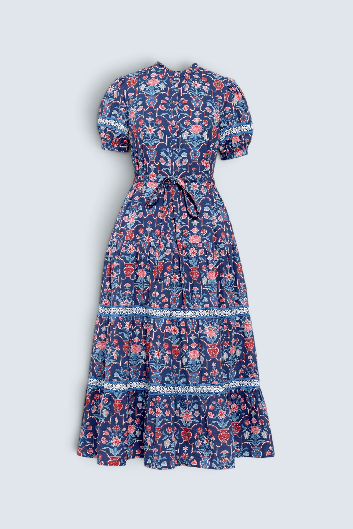 Banjanan Saylor midi shirtdress in medieval blue floral vase print with lace trim, puff sleeves, and waist belt.