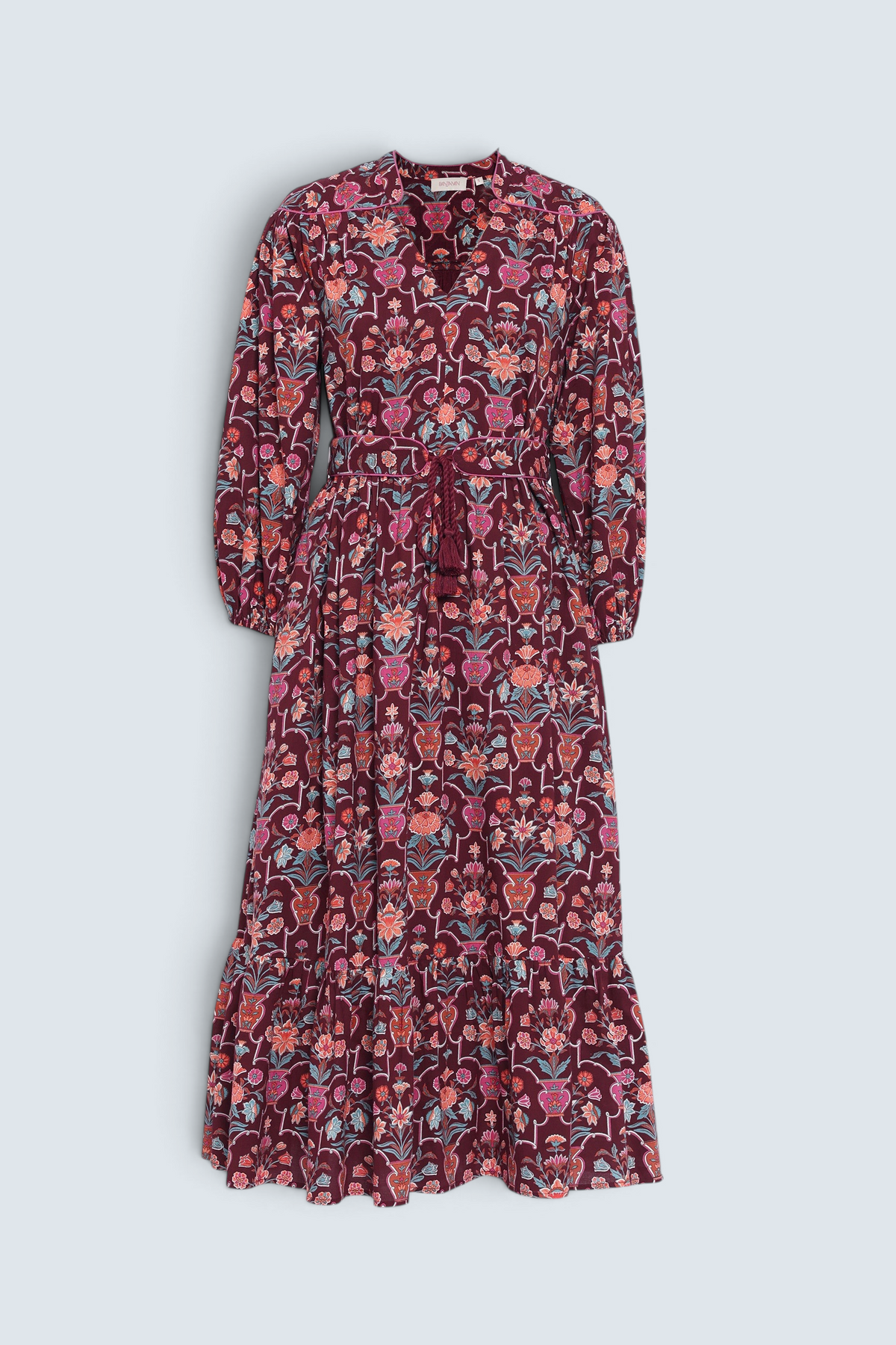 Front view of the Victoria dress in Floral Vase print. It features quilted shoulder details, piping, a tassel waist tie, and an easy silhouette.