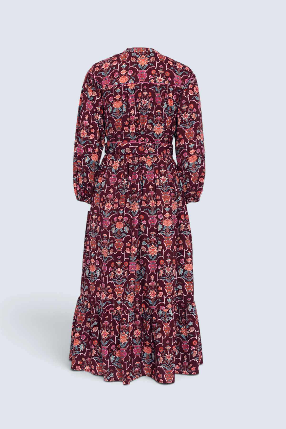 Back view of the Victoria dress in Floral Vase print. It features quilted shoulder details, piping, a tassel waist tie, and an easy silhouette.