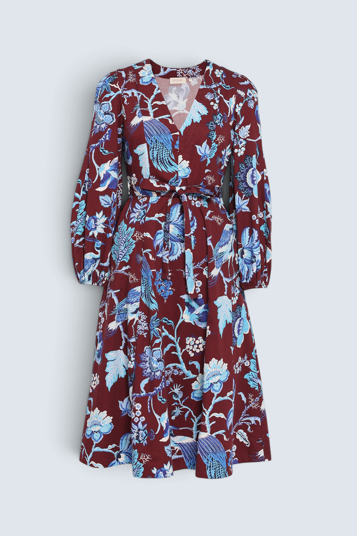 Front view the Zora dress in Chintz print, featuring a V-neck, lantern sleeves, princess seams, a gathered fit-and-flare skirt, fabric belt, and side-seam pockets.
