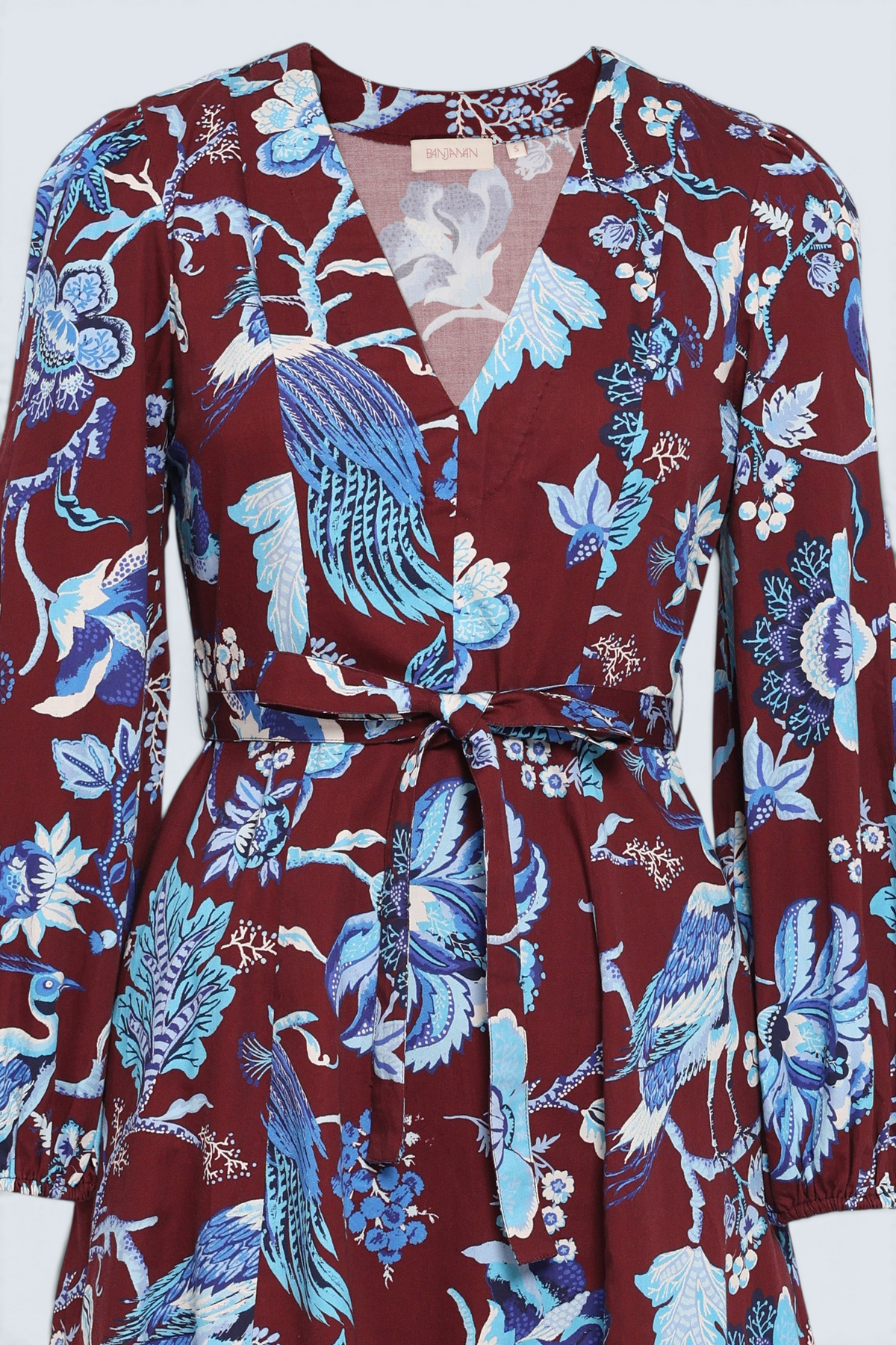 Front view close up the Zora dress in Chintz print, featuring a V-neck, lantern sleeves, princess seams, a gathered fit-and-flare skirt, fabric belt, and side-seam pockets.