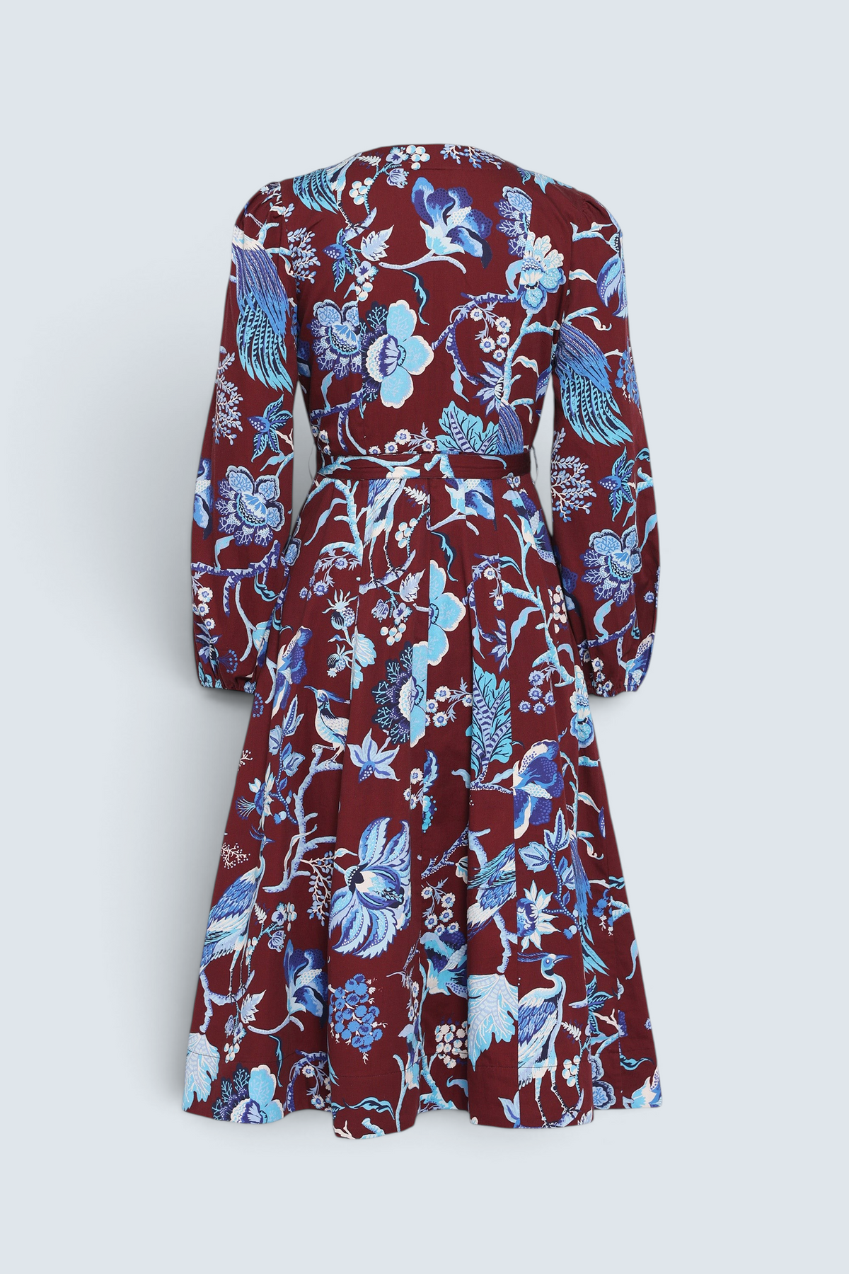 Back view of the Zora dress in Chintz print, featuring a V-neck, lantern sleeves, princess seams, a gathered fit-and-flare skirt, fabric belt, and side-seam pockets.