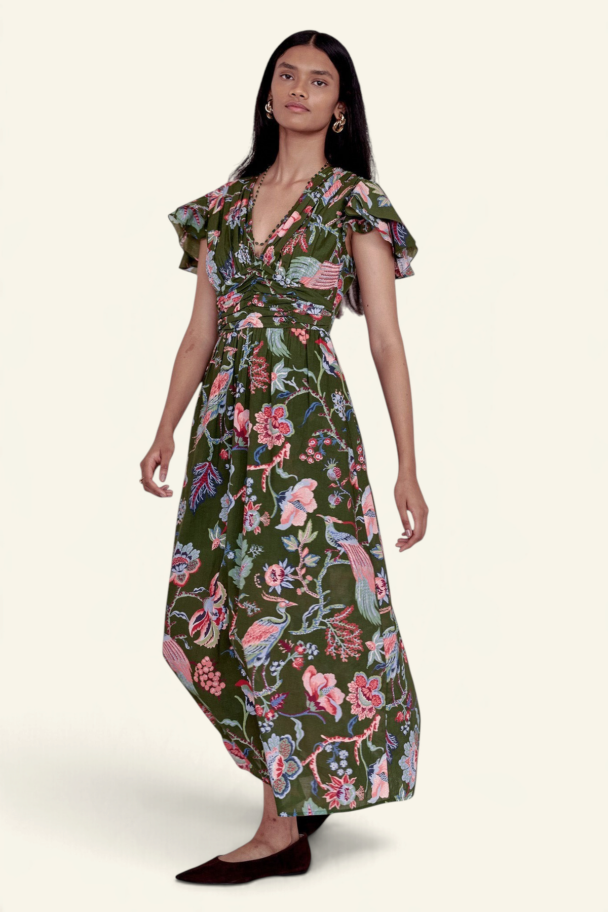 Banjanan Adele dress in moss green chintz floral print with v-neck, pleated bust, and flutter sleeves on a model.