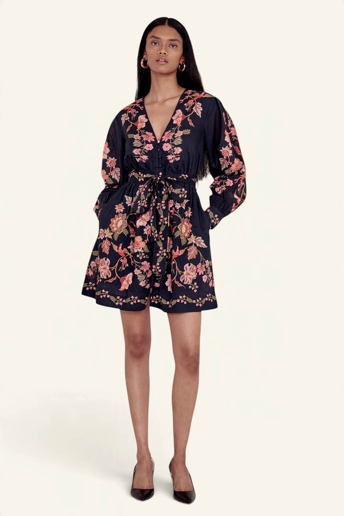 Banjanan Anne mini dress in black cotton voile with floral Chintz print, long sleeves, and fabric waist belt.