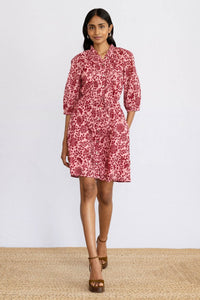 Front view of model stepping forward wearing mini Benita Dress in Komodo Candy print.