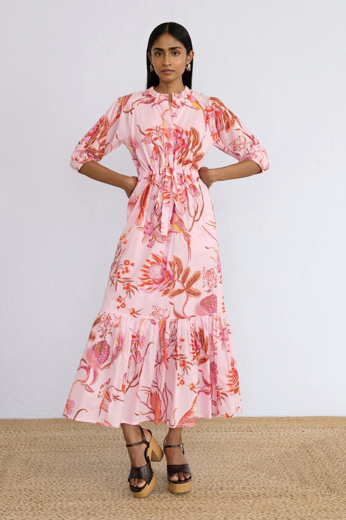 Front view of model standing wearing Betty Dress in Botany Bay Pink Mist print.