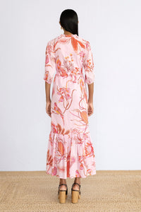 Side view of model standing wearing Betty Dress in Botany Bay Pink Mist print.