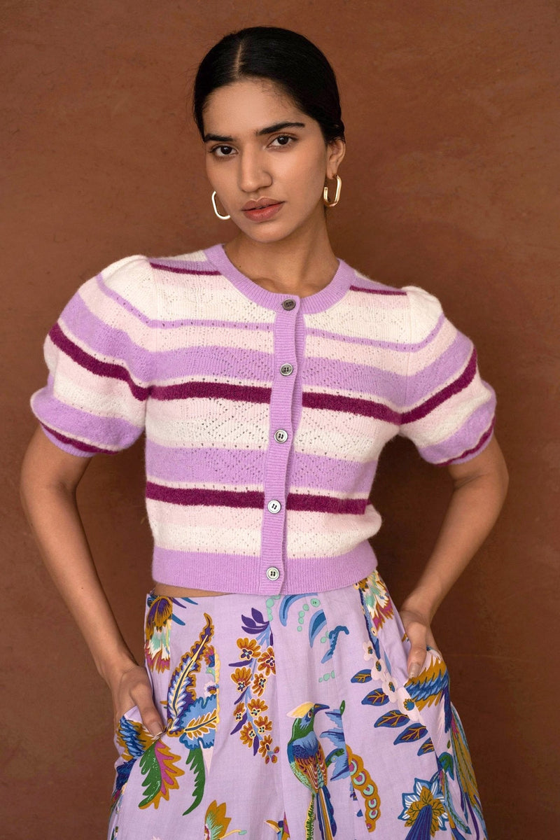 Front view of a woman wearing the Brushed Stripe Cardigan in Lilac, which hits at the waist, featuring a button placket, ribbed trim, and soft brushed yarn finish.