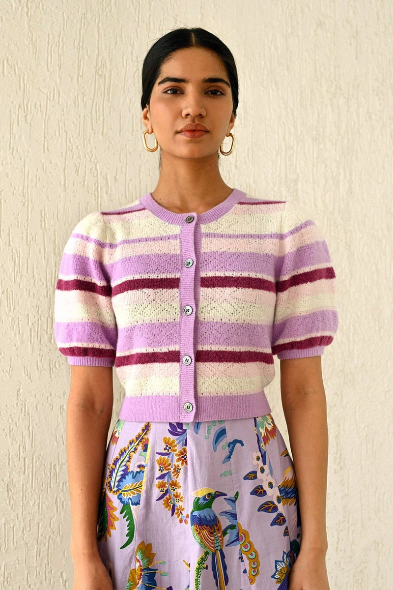 Front view of a woman wearing the Brushed Stripe Cardigan in Lilac, which hits at the waist, featuring a button placket, ribbed trim, and soft brushed yarn finish.