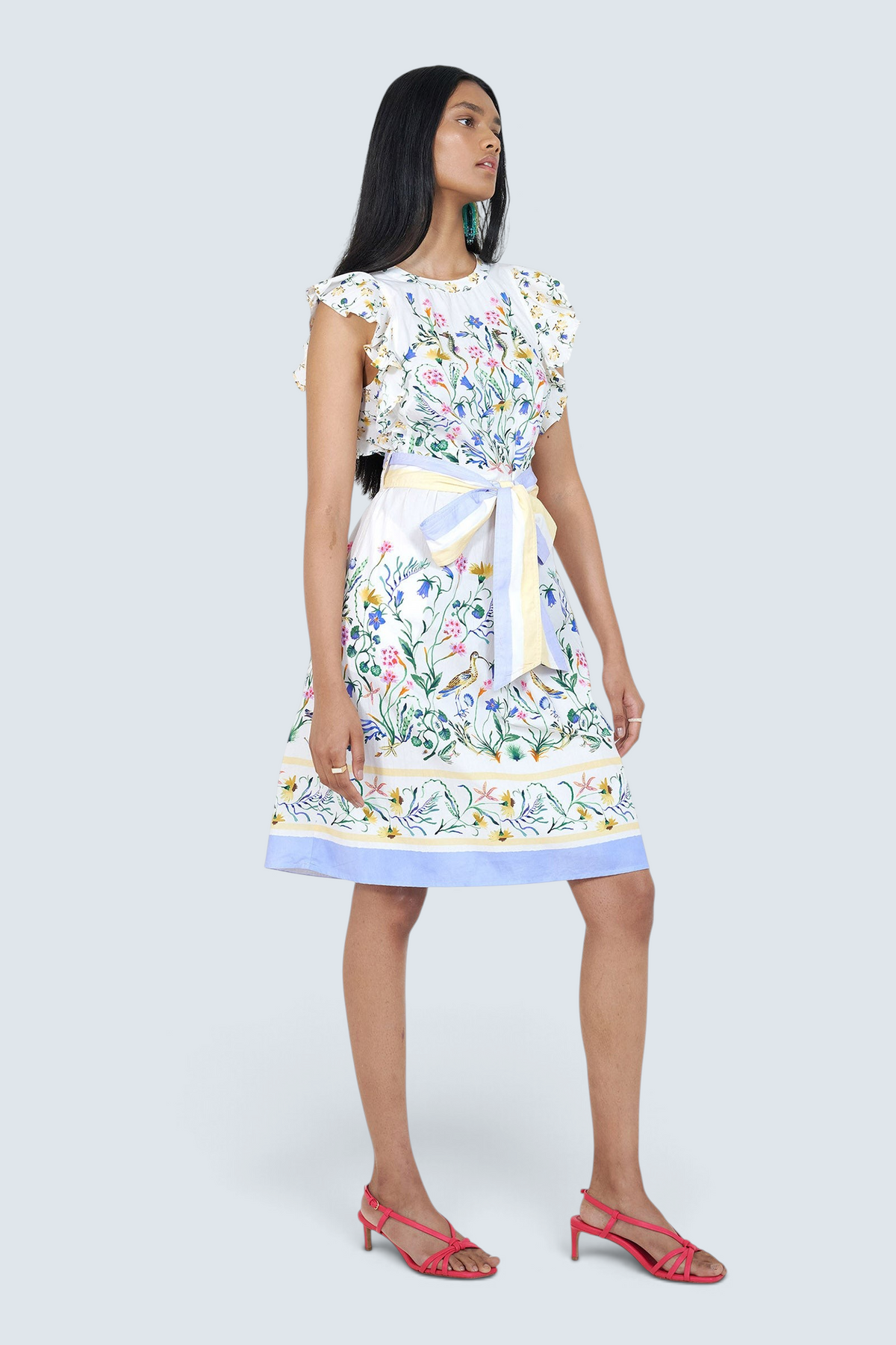 Woman wearing a floral dress with a white background