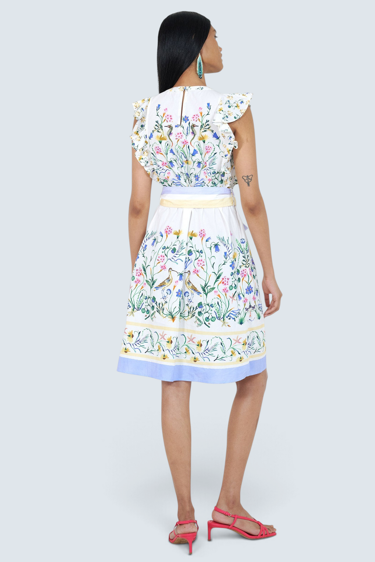 Banjanan Bulbul dress in Tidepool Grotto print with ruffled shoulders, self-belt, and keyhole back, back view.