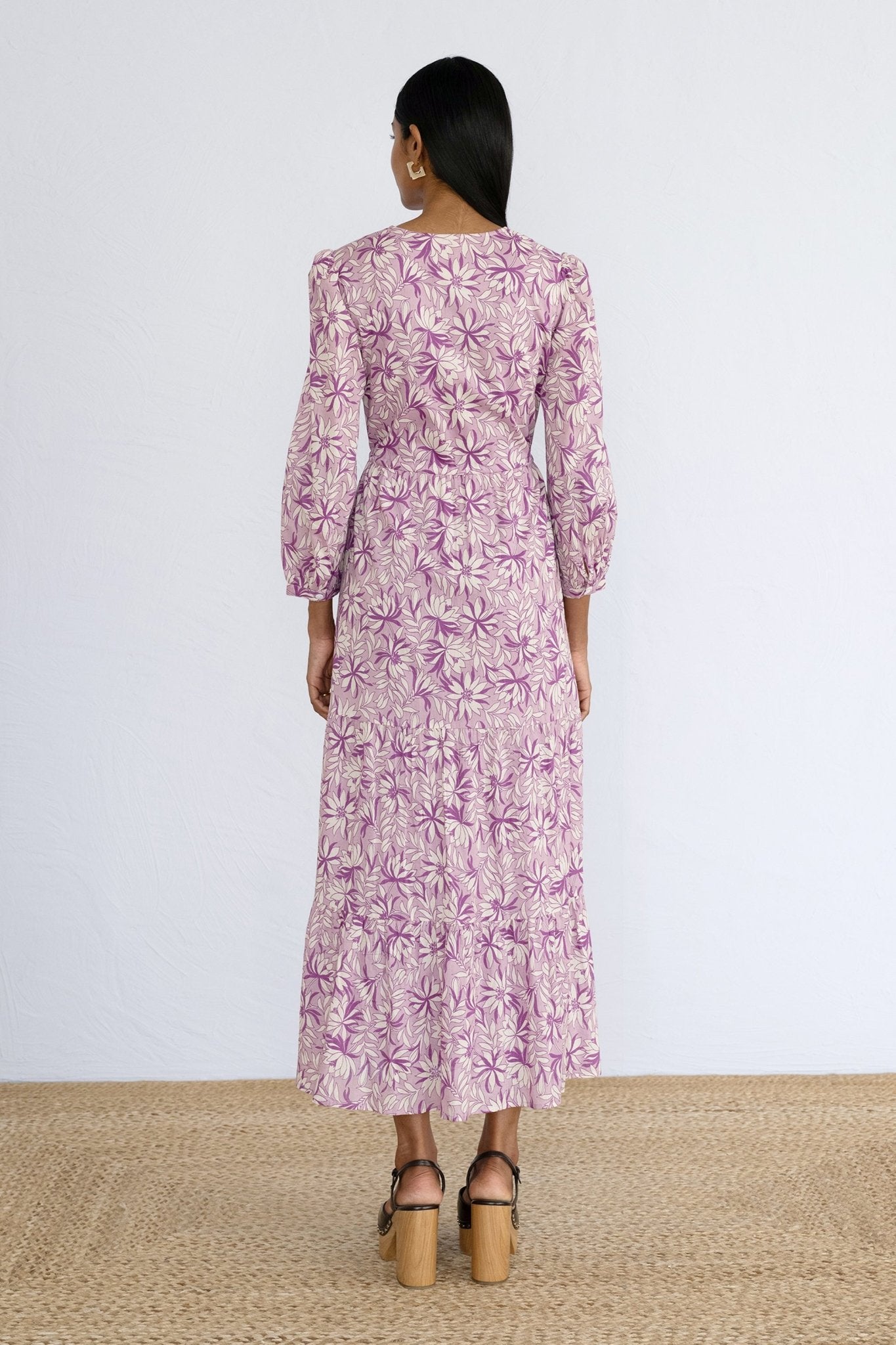 Back view of model standing wearing a full length Castor Dress in Jacaranda Lilac print.