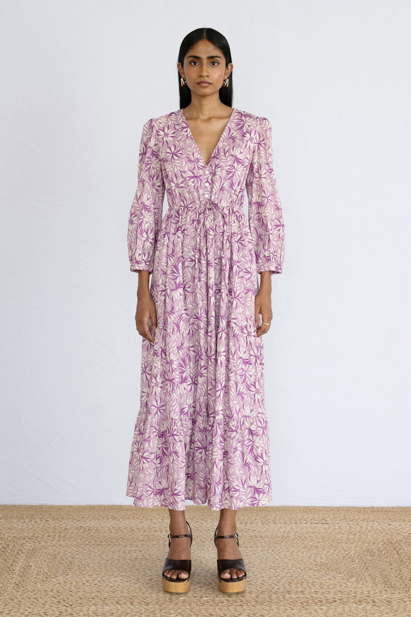 Front view of model standing wearing a full length Castor Dress in Jacaranda Lilac print.